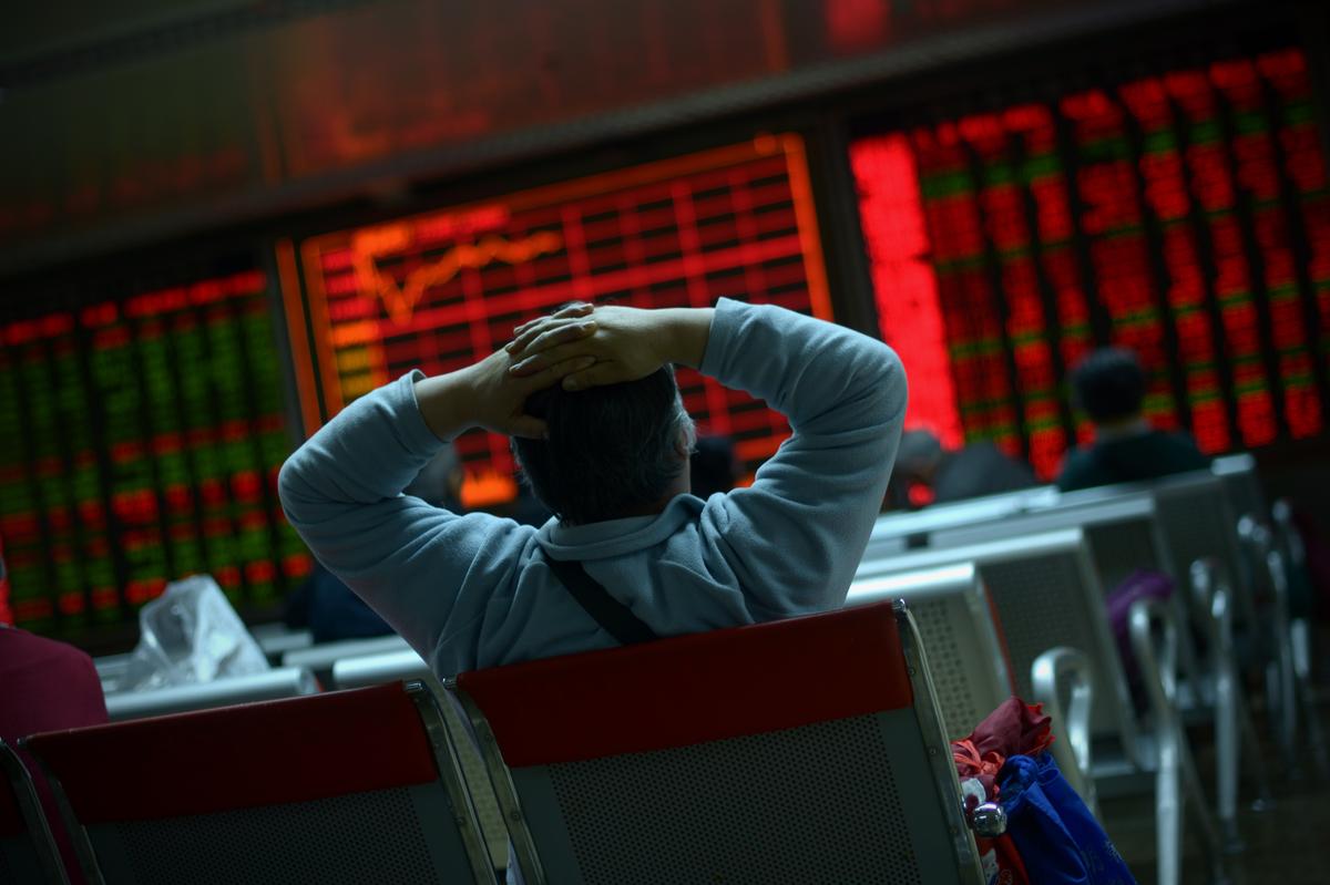 An investor looks at screens showing stock market movements at a securities company in Beijing on Jan. 8, 2016. (Wang Zhao/AFP via Getty Images)