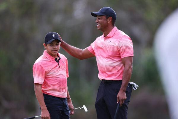 Tiger Woods of the United States and son Charlie Woods celebrate on the seventh green during the first round of the PNC Championship at Ritz-Carlton Golf Club in Orlando, Fla., on Dec. 17, 2022. (Mike Ehrmann/Getty Images)