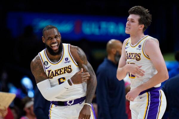 Los Angeles Lakers' LeBron James (6) celebrates with Austin Reaves (15) after making a basket assisted by Reaves during the first half of an NBA basketball game against the Washington Wizards in Los Angeles on Dec. 18, 2022. (Jae C. Hong/AP Photo)