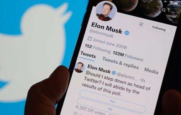 A phone displaying Elon Musk's Twitter page where he is conducting a survey about his future as the head of the company, in a photo illustration taken in Los Angeles on Dec. 18, 2022. (Chris Delmas/AFP via Getty Images)