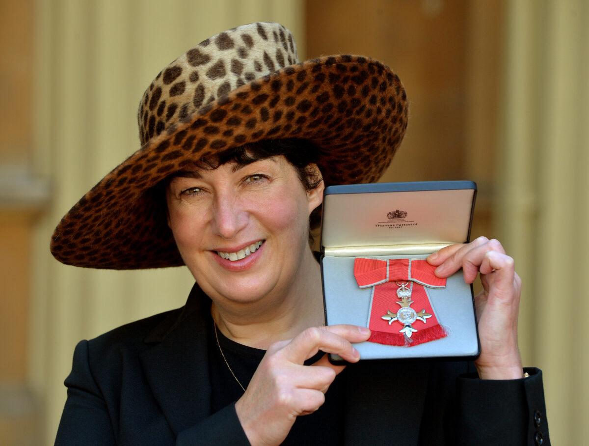 Joanne Harris holding her MBE for services to literature after it was presented to her by Queen Elizabeth II at an Investiture Ceremony at Buckingham Palace in London on Oct. 10, 2013. (John Stillwell - WPA Pool/ Getty Images)