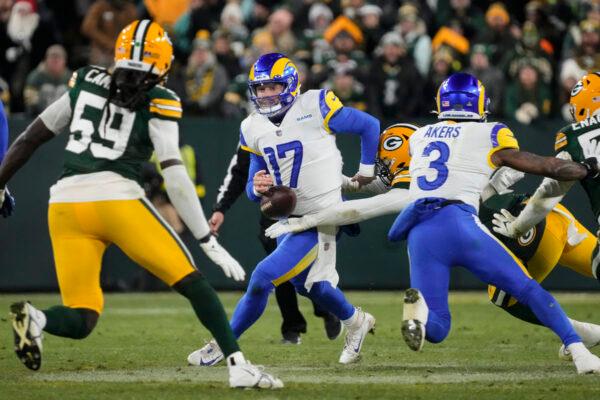 Los angles Rams quarterback Baker Mayfield (17) fumbles from hit by Green Bay Packers linebacker Quay Walker (7)—the Rams recovered the ball in the first half of an NFL football game in Green Bay, Wis. on Dec. 19, 2022. (Morry Gash/AP Photo)