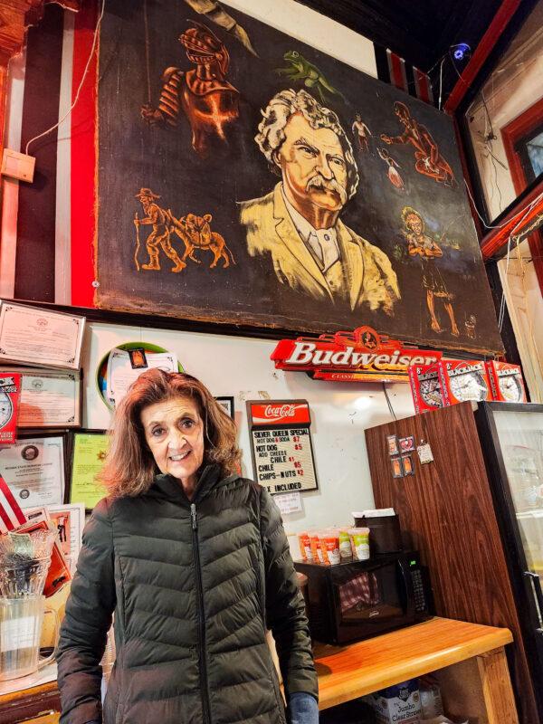 Constance Carlson, co-owner of the Silver Queen Hotel Saloon in Virginia City, Nev., said business has been good in 2022, and should get even better in 2023 as tourism is on the rise since the pandemic. (Below) Carlson gets ready to cash out at closing time. (Allan Stein/The Epoch Times)