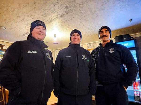 Virginia City, Nev., paramedics Daniel Sinclair (L) Chief Shane Dixon (C), and Derek Giuralani (R) take a quick break from the winter storm on Dec. 10, 2022. (Allan Stein/The Epoch Times)