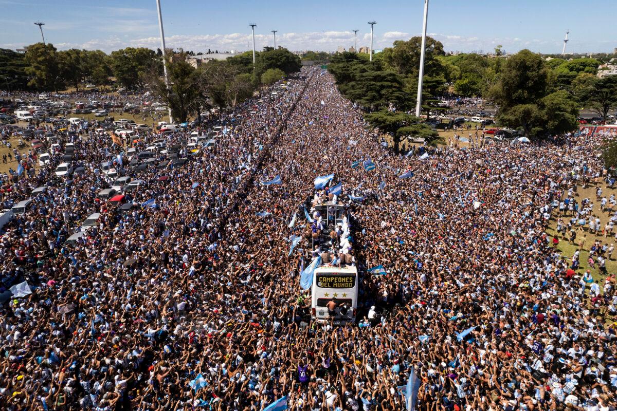 The Argentine soccer team that won the World Cup title ride on an open bus during their homecoming parade in Buenos Aires, Argentina, on Dec. 20, 2022. (Rodrigo Abd/AP Photo)