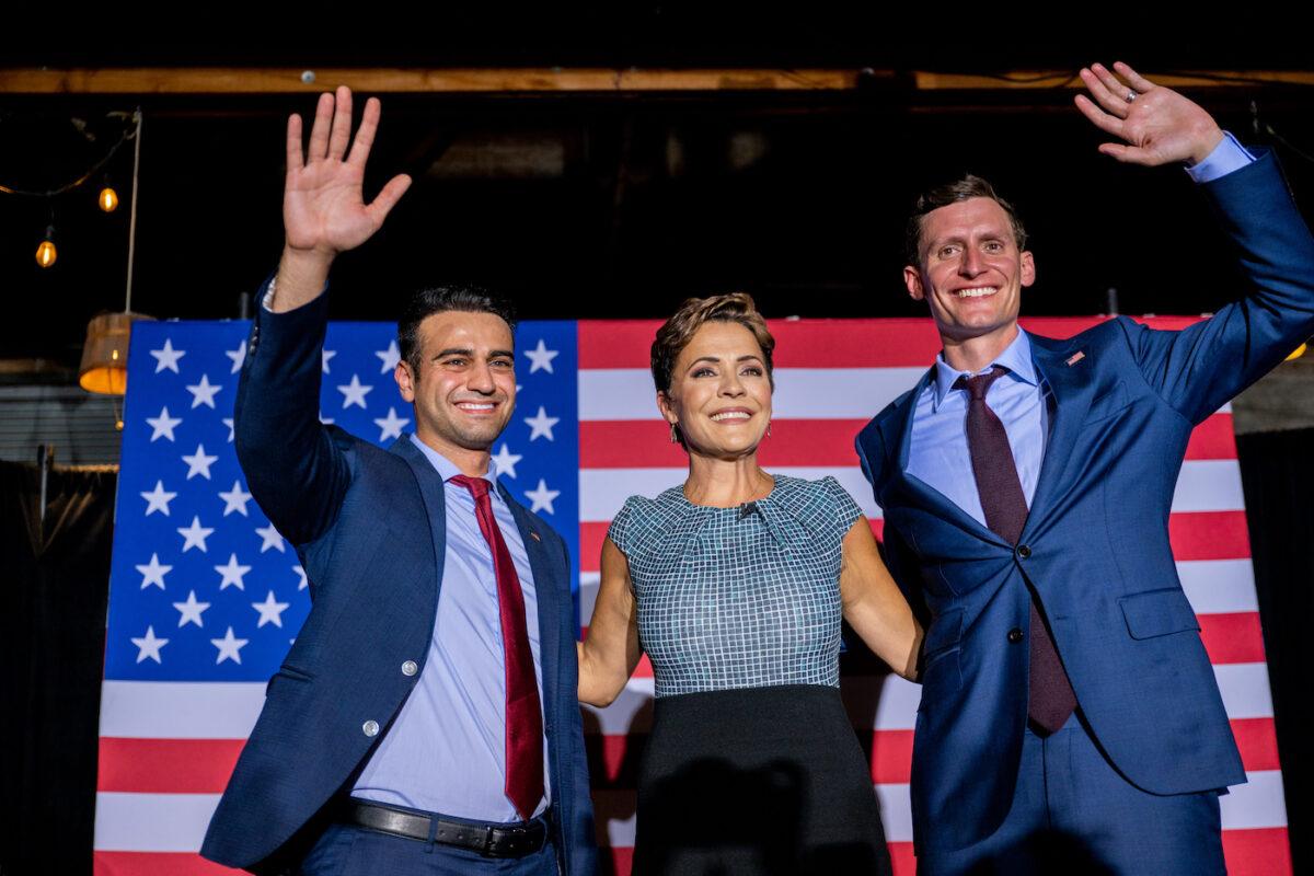 Republican candidate for state attorney general Abraham Hamadeh (L), Republican gubernatorial candidate Kari Lake, and Republican U.S. Senate candidate Blake Masters wave to supporters at the conclusion of a campaign event on the eve of the primary at the Duce bar in Phoenix, Ariz., on Aug. 1, 2022. (Brandon Bell/Getty Images)