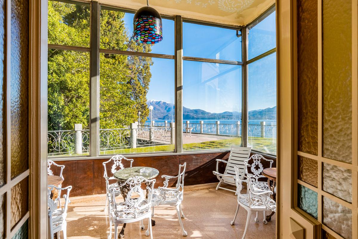 The villa's many expansive windows allow the owners and guests to enjoy relaxing views of Lake Maggiore. (Courtesy of Italy Sotheby's International Realty)