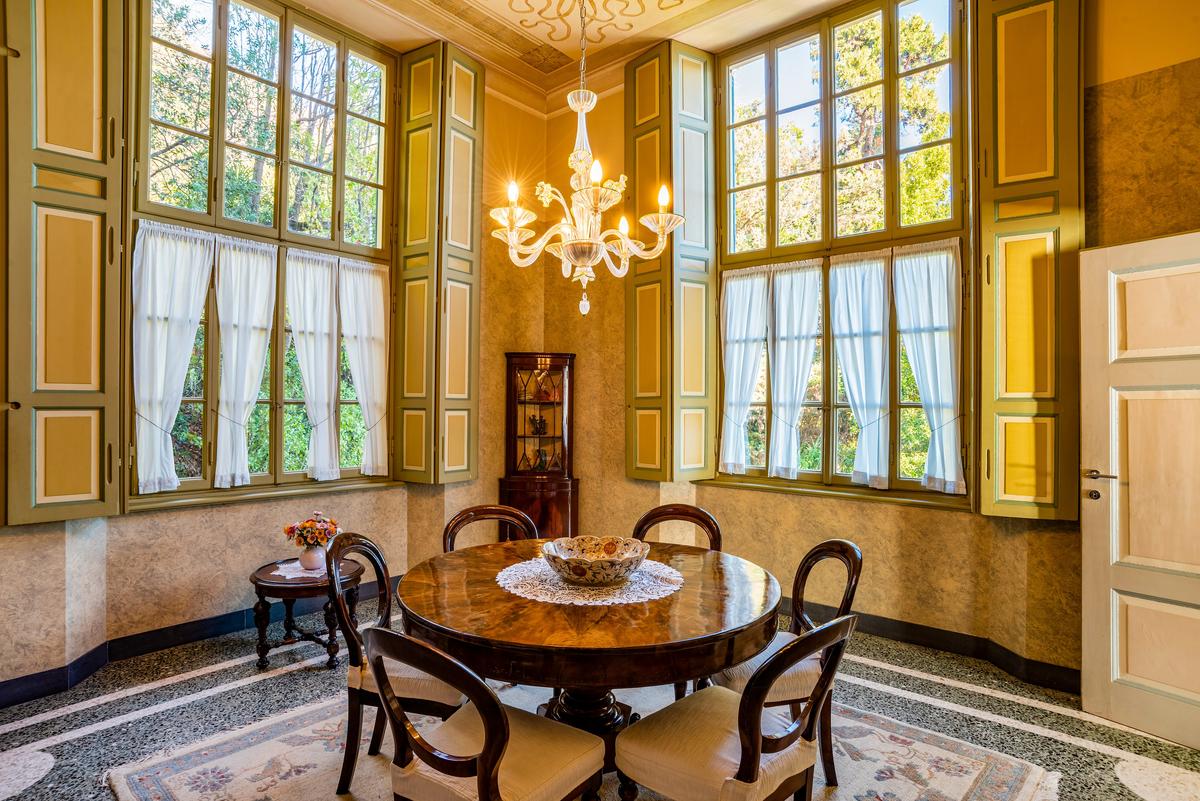 The upper level dining room features sensual Art Nouveau details and soothing natural tones. (Courtesy of Italy Sotheby's International Realty)
