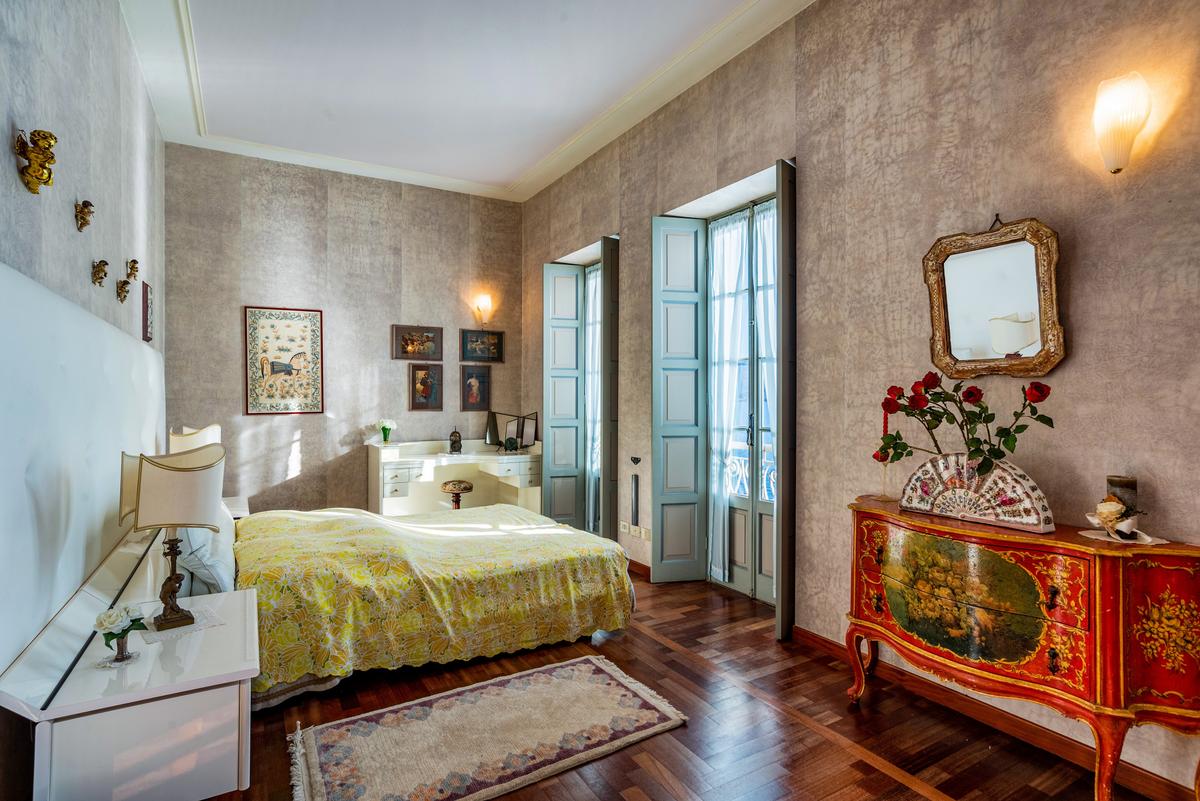 The villa's airy and spacious bedrooms feature large windows to take in Lake Maggiore's picturesque beauty. (Courtesy of Italy Sotheby's International Realty)