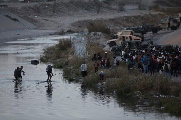 People cross the Rio Grande towards the U.S.–Mexico border in Ciudad Juarez, Mexico, on Dec. 20, 2022. (Christian Chavez/AP Photo)
