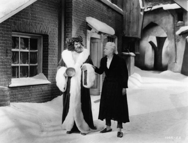 The Ghost of Christmas Present (Lionel Braham, L) shows Scrooge how others celebrate in 1938's "A Christmas Carol." (MovieStillsDB)