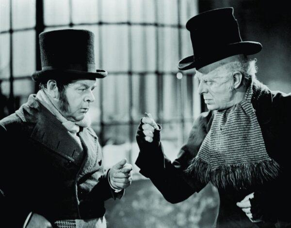 It was almost a family affair for the actor playing Bob Cratchit (Gene Lockhart, L) in this scene with Ebenezer Scrooge (Reginald Owen) in 1938's "A Christmas Carol." (MovieStillsDB)