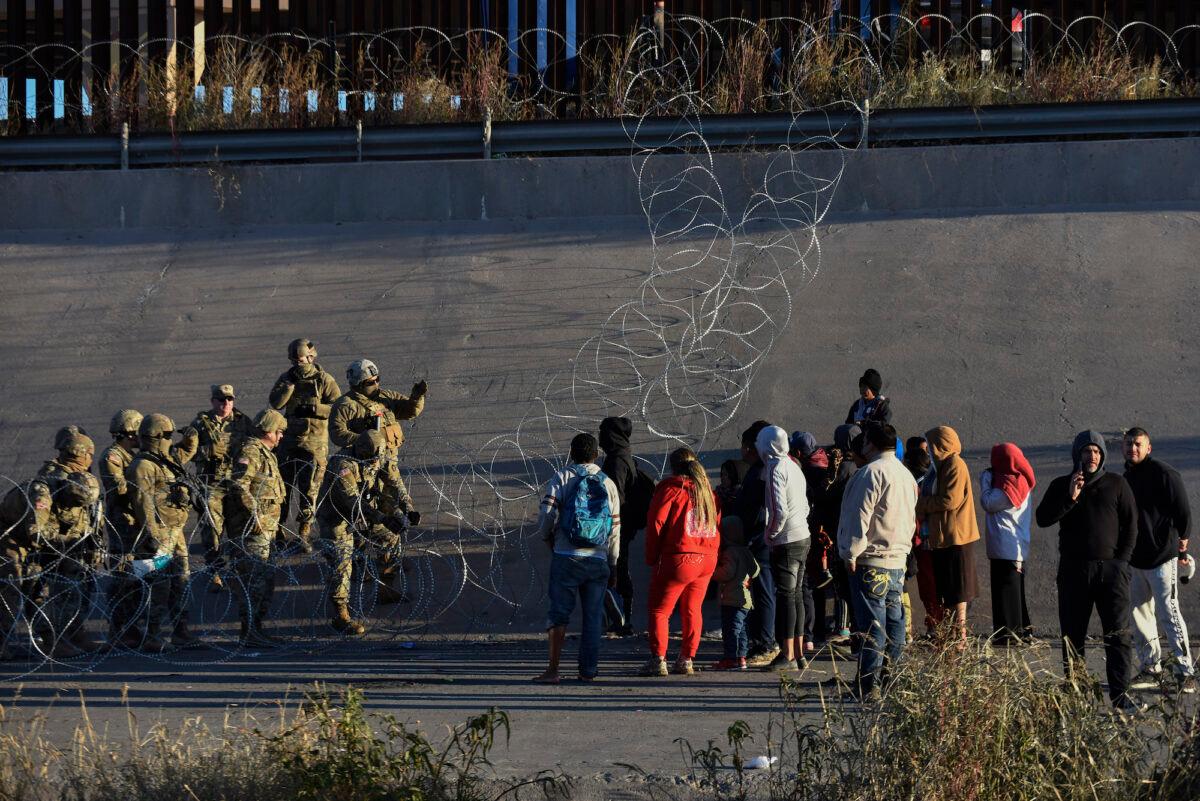 U.S. military stop people from crossing into El Paso, Texas, seen from Ciudad Juarez, Mexico, on Dec. 20, 2022. (AP Photo/Christian Chavez)