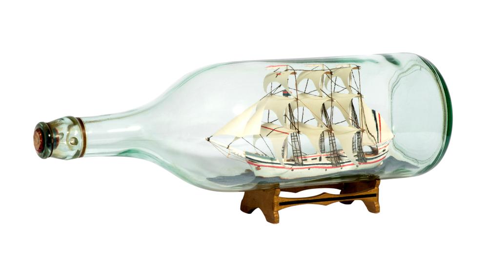 Building a ship in a bottle is a challenging task that helps pass the time when it’s too cold to venture outside.<br/>(Photology1971/Shutterstock)