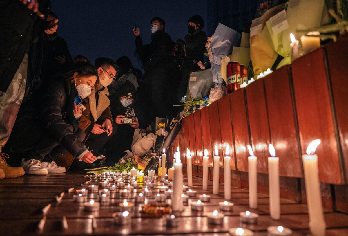 Protesters in Beijing gather at a memorial on Nov. 27, 2022, after at least 10 people die in a Xinjiang apartment building fire blamed on the Chinese regime’s restrictive zero-COVID measures. (Kevin Frayer/Getty Images)