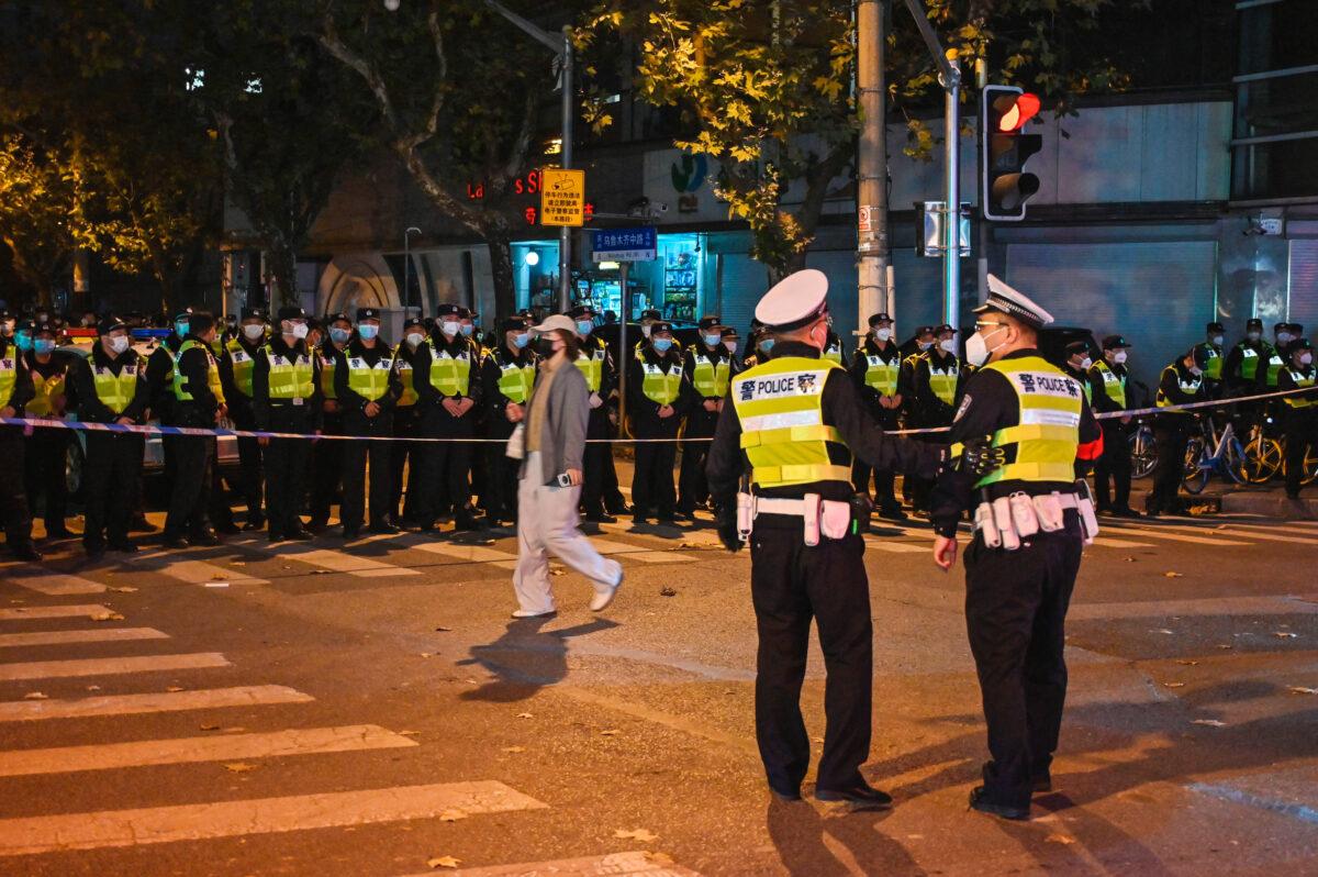 Police officers block Wulumuqi Street in Shanghai on Nov. 27, 2022, where protests against zero-COVID took place the previous night in response to a deadly fire in Urumqi, Xinjiang. (HECTOR RETAMAL/AFP via Getty Images)