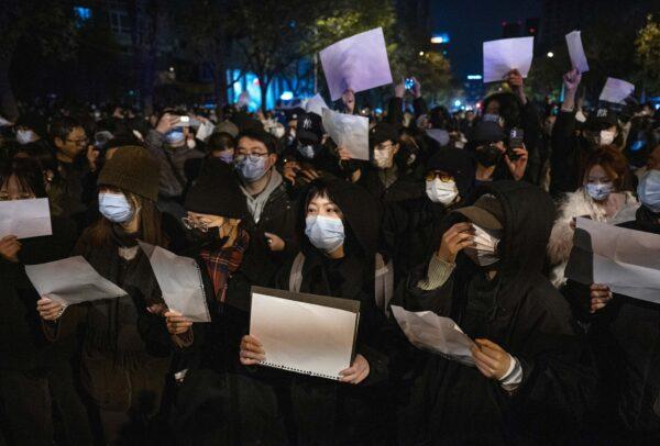 Protesters in Beijing hold up white pieces of paper to protest against censorship and China’s strict zero-COVID measures on Nov. 27, 2022. (Kevin Frayer/Getty Images)