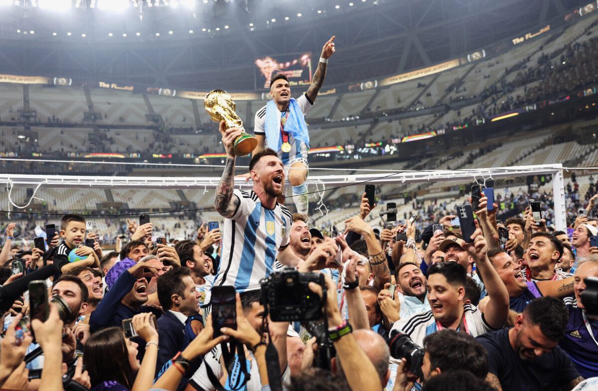 Argentina’s Lionel Messi holds aloft the soccer World Cup trophy after leading his team to beat France in a dramatic final for his first and Argentina’s third World Cup victory, in Qatar on Dec. 18, 2022. (Clive Brunskill/Getty Images)