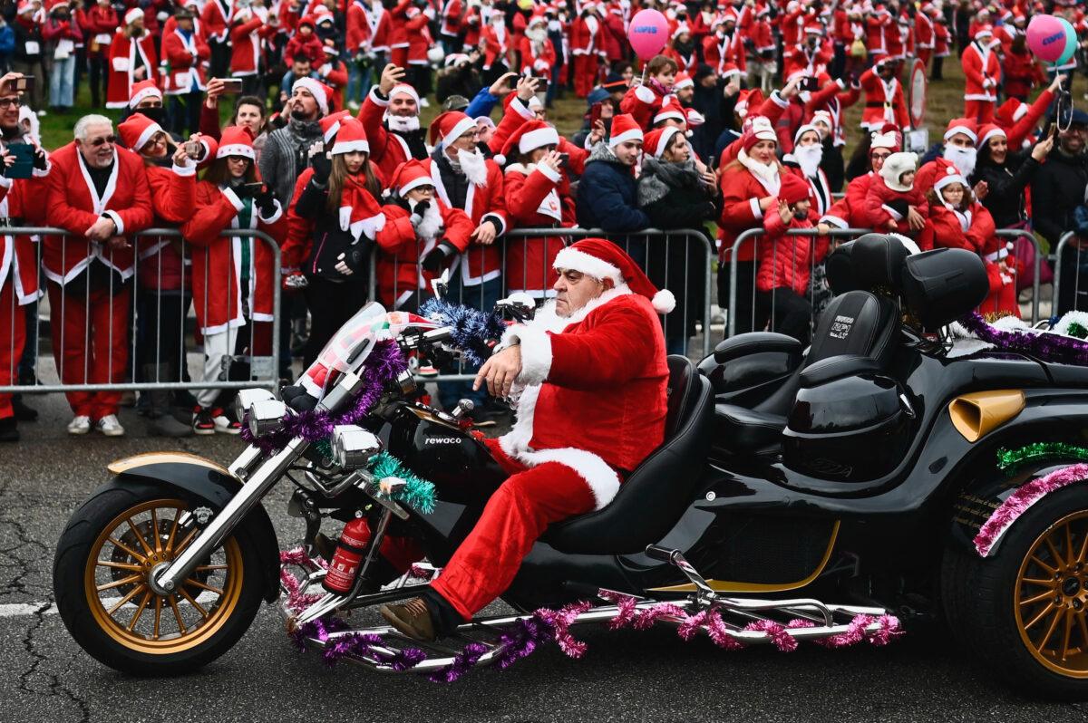 A man dressed as Santa Claus rides his motorbike during the 12th Santa Claus "Papa Noel" charity rally in Turin, Italy, on Dec. 4, 2022, to raise funds for a pediatrics health care facility. (MARCO BERTORELLO/AFP via Getty Images)