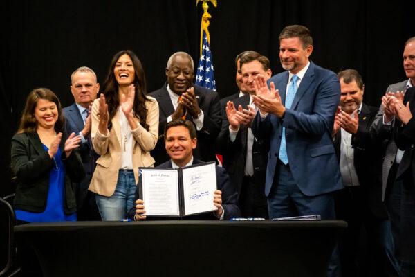 Florida Gov. Ron DeSantis celebrates signing into law provisions that would ban certain discussions about sexual orientation and gender identity in school classrooms from kindergarten to third grade, on March 28, 2022. (Courtesy of Florida Governor's Office)