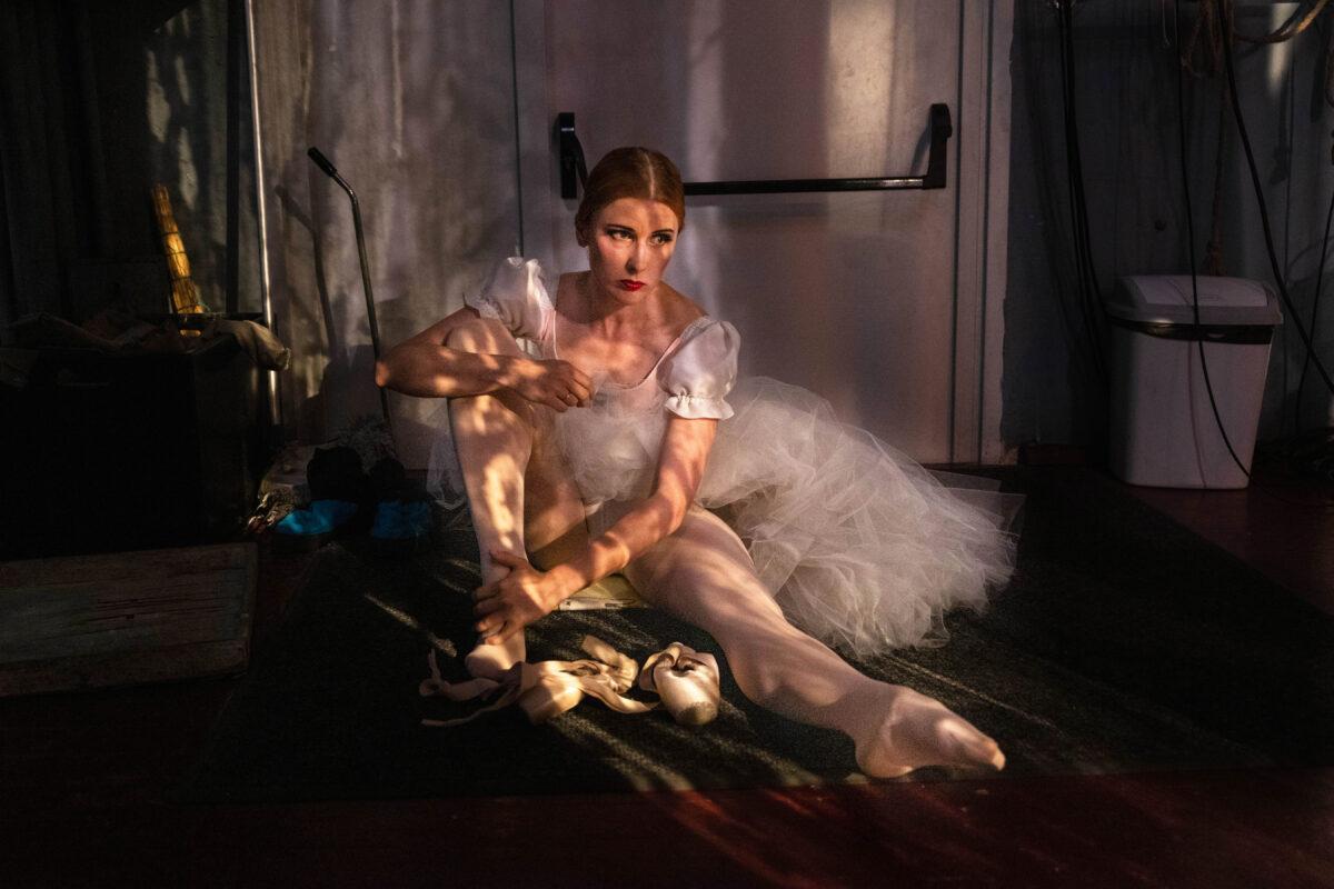 A ballet dancer sits backstage during a performance of "Giselle" in Lviv, Ukraine, on June 10, 2022. The Lviv National Opera house resumed performances in May, but limited the audience to 300 people, which is the capacity of its bomb shelter. (Paula Bronstein/Getty Images)