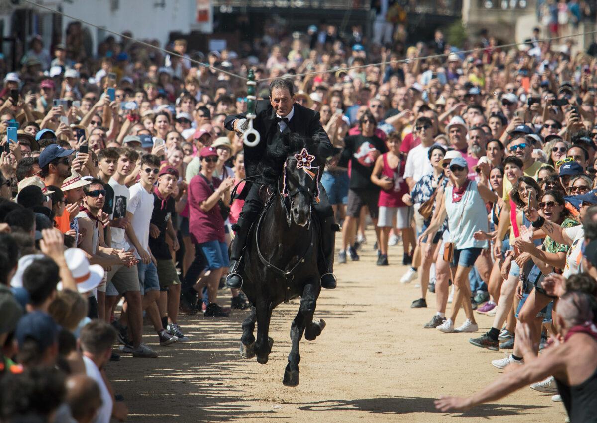 A rider gallops on his horse with a lance during the traditional San Juan festival in the town of Ciutadella, on the Balearic Island of Menorca, on June 24, 2022. (JAIME REINA/AFP via Getty Images)