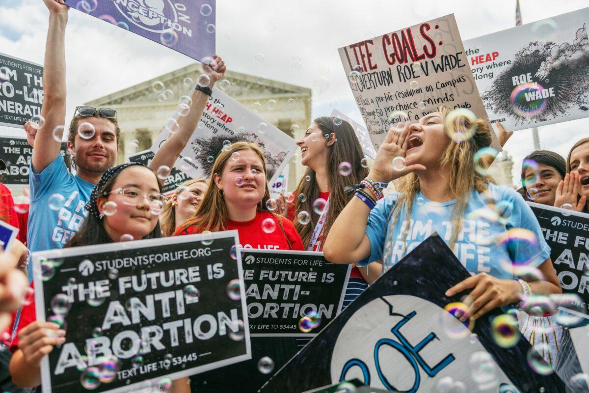 Pro-life activists celebrate outside the Supreme Court after the top court ruled to erase a federal right to an abortion and sent abortion law to the states to decide, on June 24, 2022. (Brandon Bell/Getty Images)