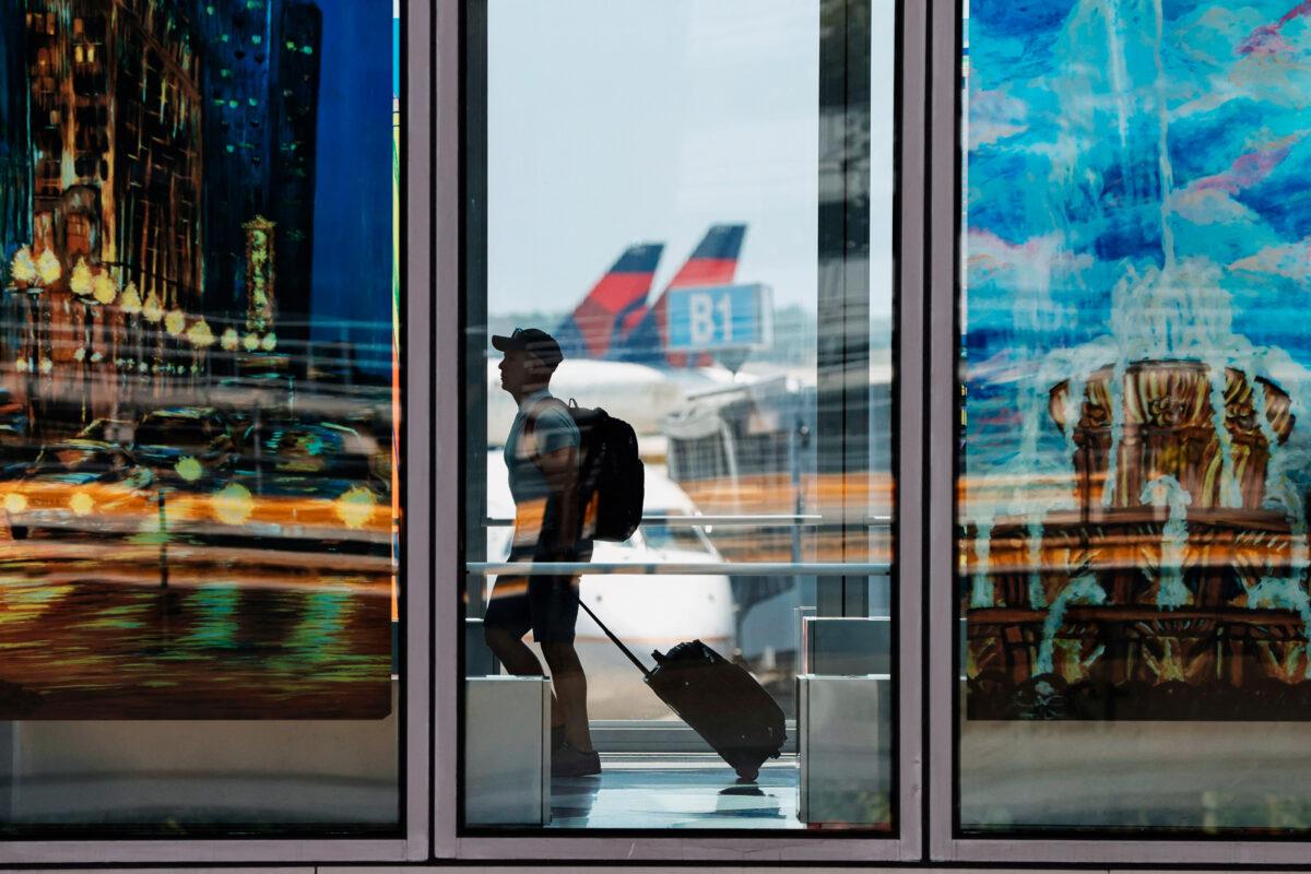 A traveler passes through O'Hare International Airport in Chicago. The Biden administration announced the end of the COVID-19 testing requirement for international travel, on June 10, 2022. (KAMIL KRZACZYNSKI/AFP via Getty Images)