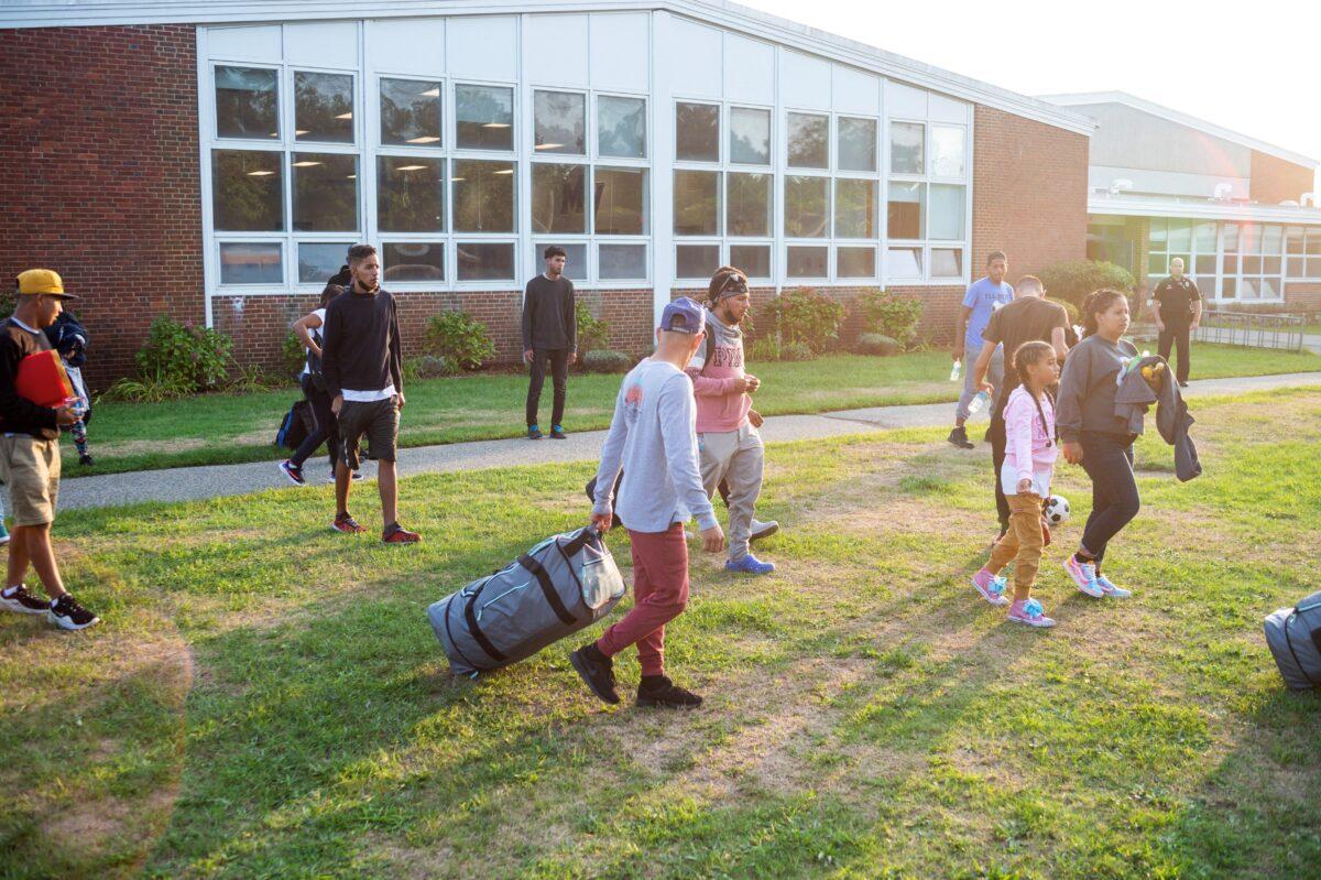 About 50 Venezuelans who recently crossed the U.S. border illegally are at the Martha's Vineyard Regional High School in Massachusetts on Sept. 14, 2022, after being flown there by Florida Gov. Ron DeSantis. (Ray Ewing/Vineyard Gazette/Handout via Reuters)