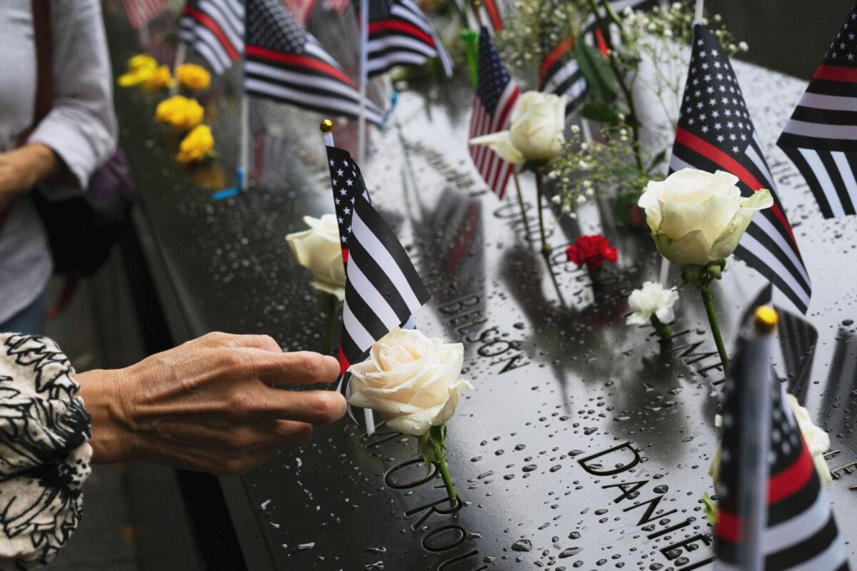 People pay their respects at the World Trade Center Memorial in New York on Sept. 11, 2022. (Chung I Ho/The Epoch Times)