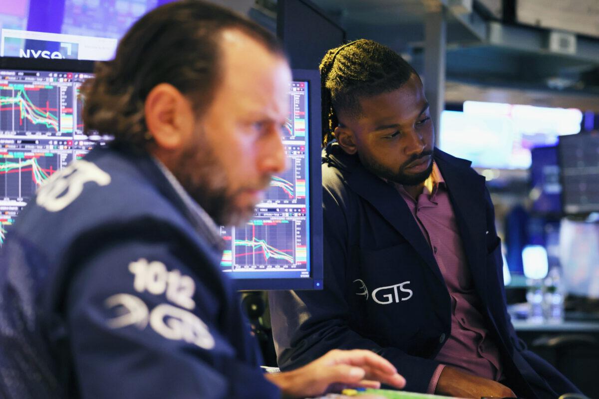 Traders work at the New York Stock Exchange on Sept. 13, 2022. The Dow Jones Industrial Average drops 1,276 points, or just under 4 percent, after a monthly inflation report, effectively erasing recent gains. (Michael M. Santiago/Getty Images)