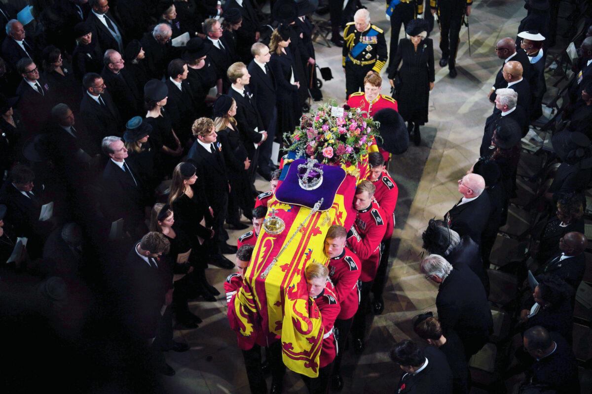 Queen Elizabeth II's coffin is carried into St George's Chapel in Windsor Castle in England for her committal service following a state funeral at Westminster Abbey on Sept. 19, 2022. The Queen died at Balmoral Castle in Scotland on Sept. 8. (Ben Birchall-WPA Pool/Getty Images)