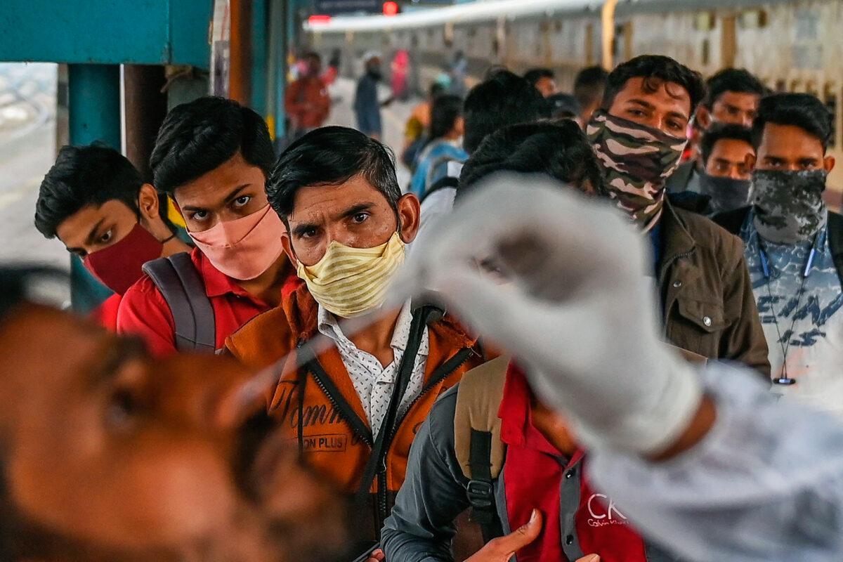 People line up for a nasal swab COVID-19 test in Mumbai, India,Jan. 7, 2022. The number of COVID-19 cases worldwide has just exceeded 300 million. (PUNIT PARANJPE/AFP via Getty Images)