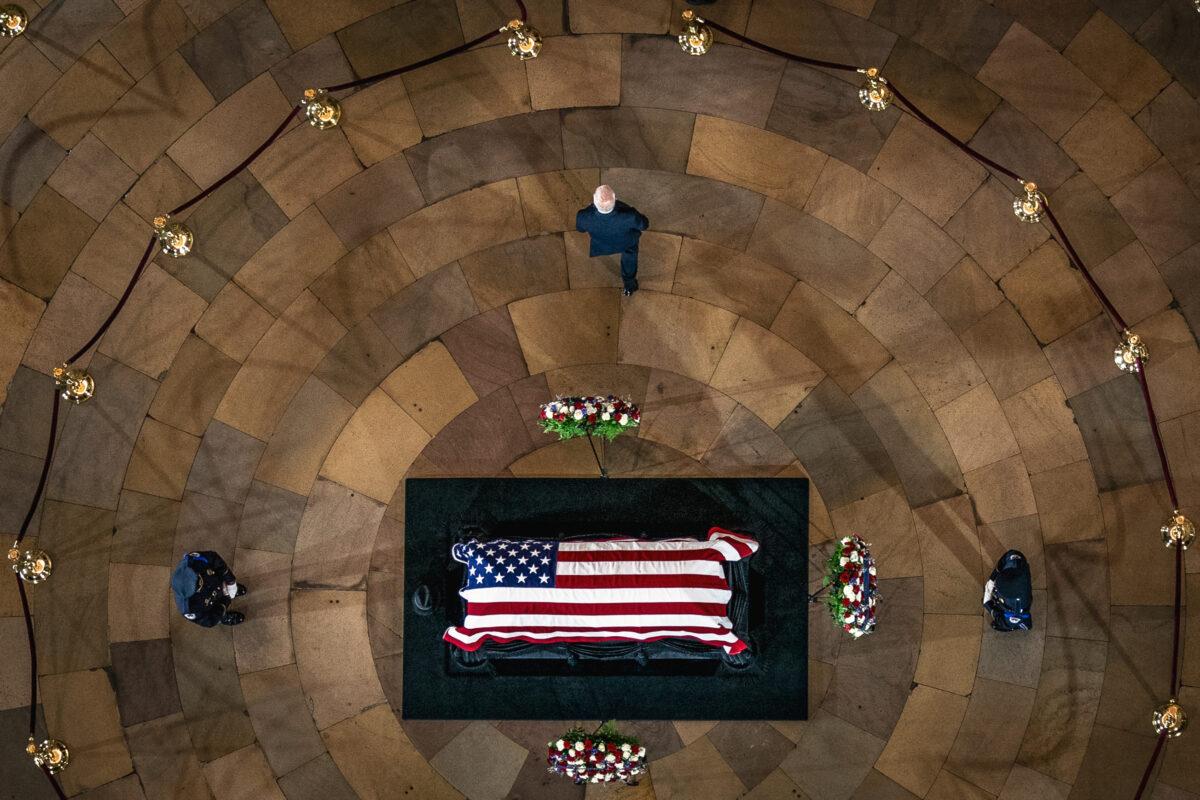 President Joe Biden walks away after paying respects at the casket of former U.S. Sen. Harry Reid, who lies in state in the Rotunda of the U.S. Capitol, on Jan. 12, 2022. (ANDREW HARNIK/POOL/AFP via Getty Images)