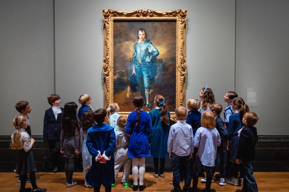 Children look at "The Blue Boy" by English artist Thomas Gainsborough at the National Gallery in London on Jan. 24, 2022. The painting is on display in the UK for the first time in 100 years. (TOLGA AKMEN/AFP via Getty Images)