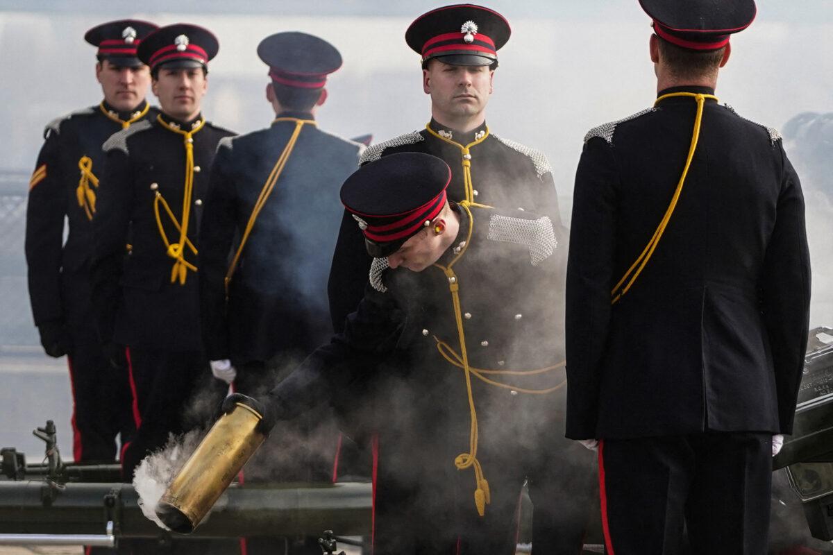 A member of the Honourable Artillery Company loads a cannon for a gun salute in front of London's Tower Bridge to mark the 70th anniversary of Queen Elizabeth II's accession to the throne, on Feb. 7, 2022. (NIKLAS HALLE'N/AFP via Getty Images)