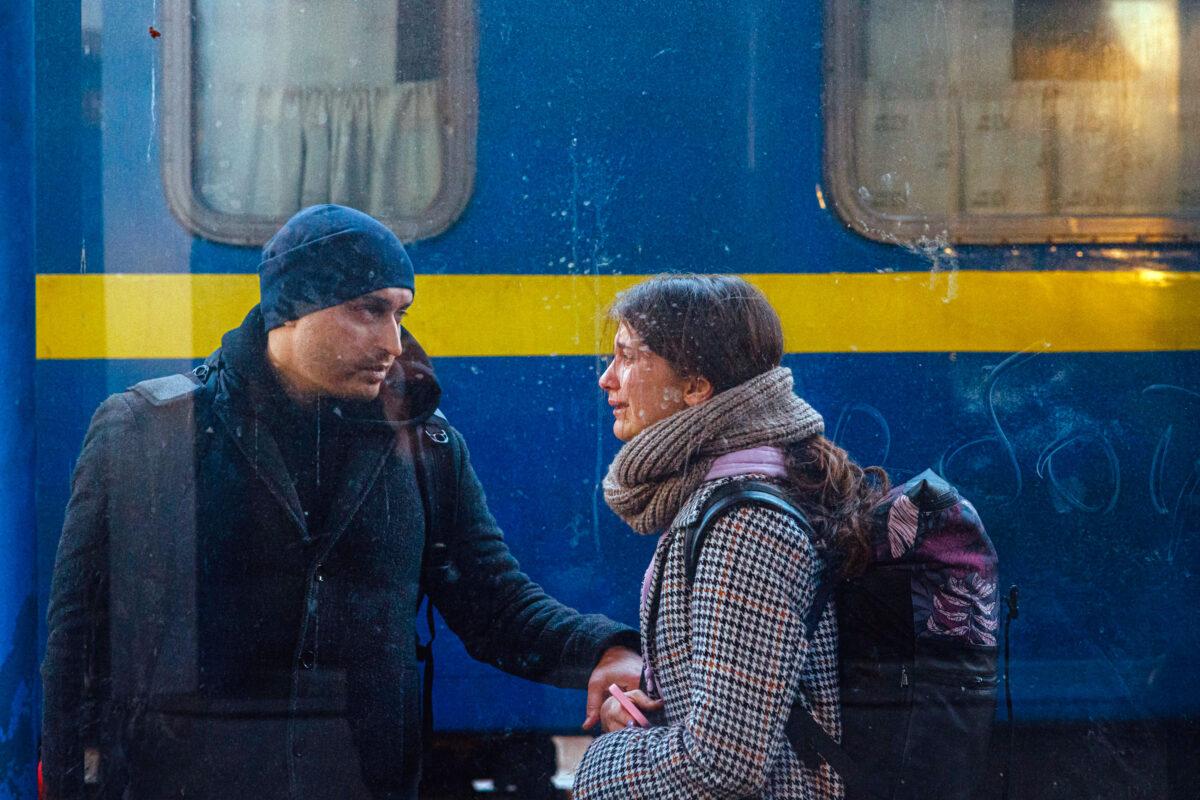 A couple prepares to evacuate by train from Ukraine's capital city, Kyiv, as Russia's invasion enters its fifth day, on Feb. 28, 2022. (DIMITAR DILKOFF/AFP via Getty Images)