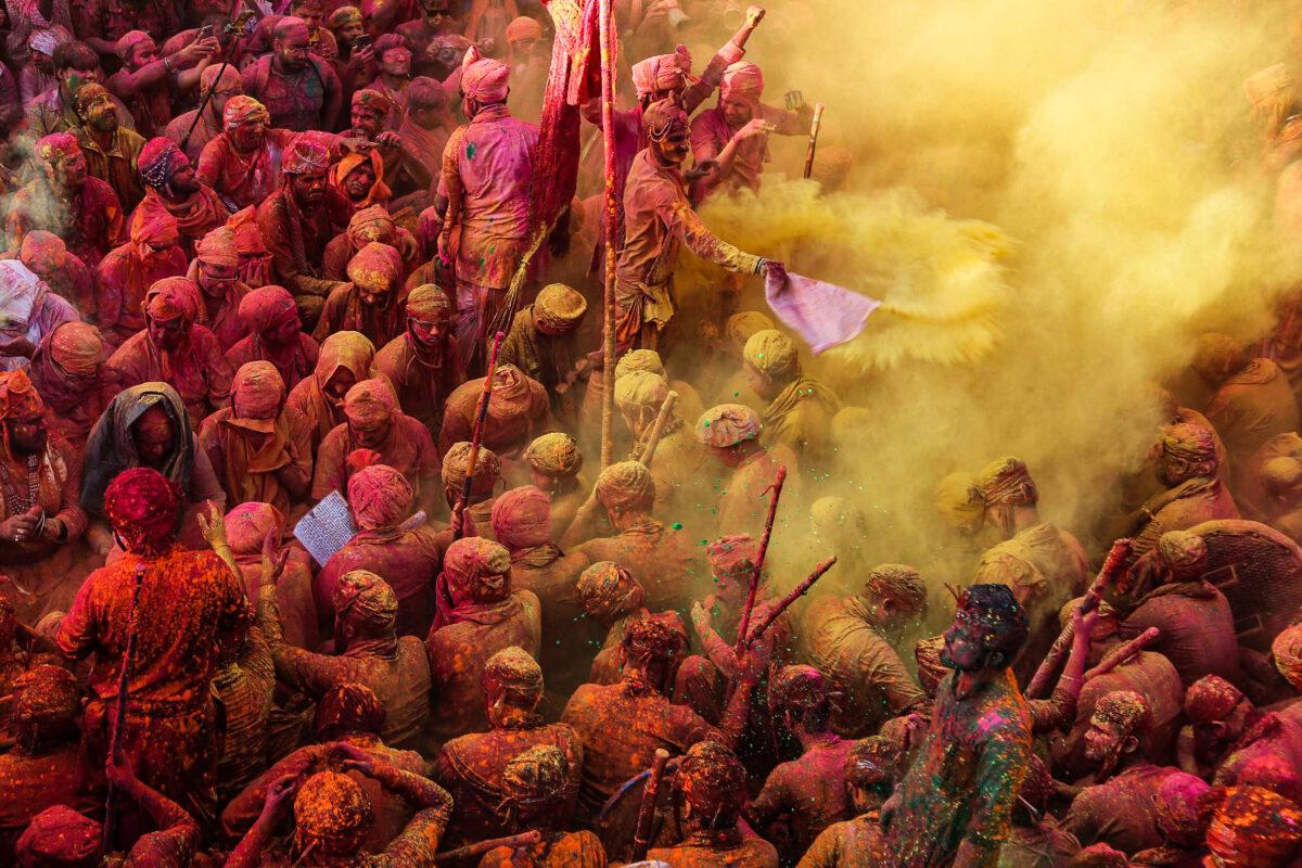 Revelers awash in color sing hymns during the Hindu spring festival of colors at Nandgaon village in India's Uttar Pradesh state, on March 12, 2022. (AFP via Getty Images)