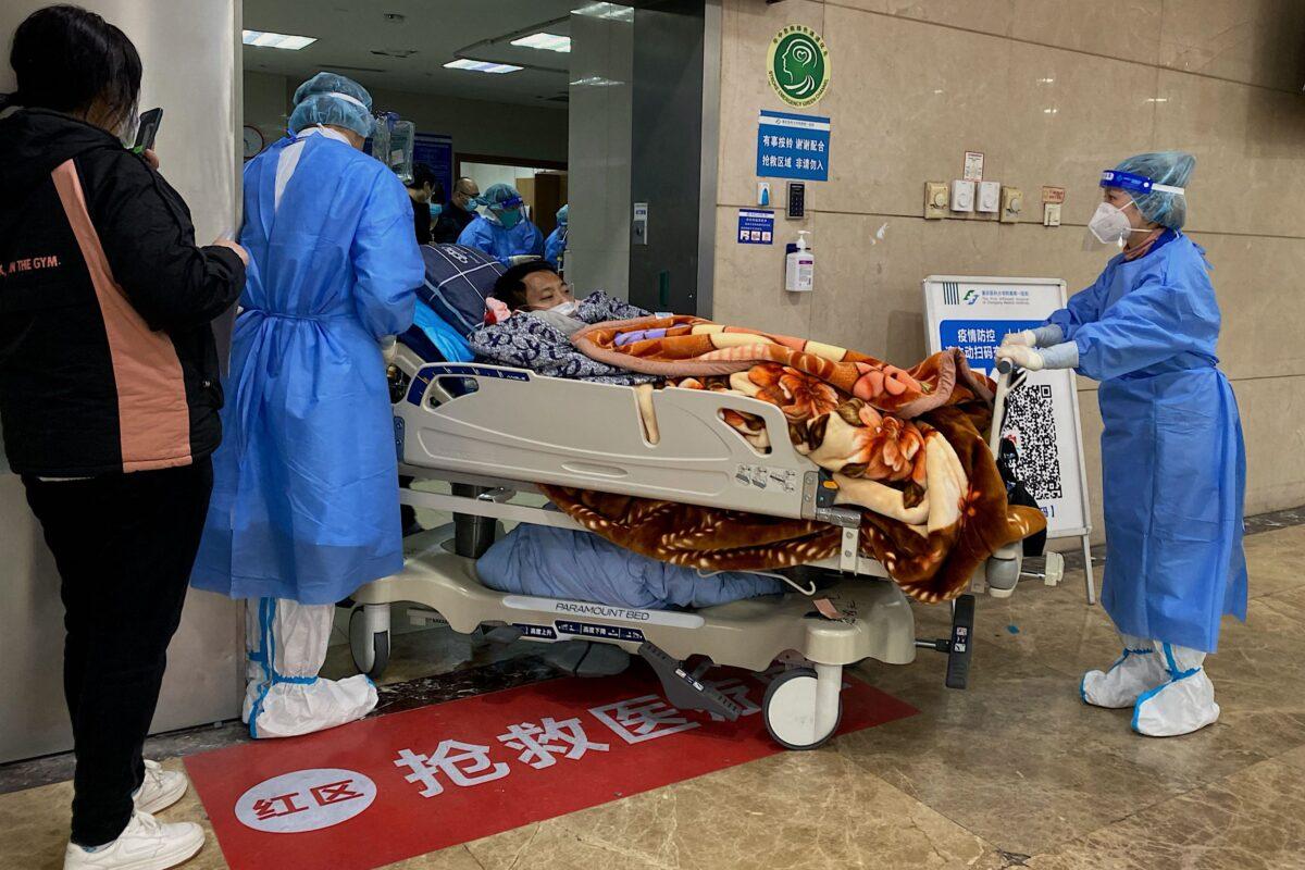 Health workers moving a COVID-19 patient on a stretcher in the emergency ward of the First Affiliated Hospital of Chongqing Medical University in Chongqing, China, on Dec. 22, 2022. (Noel Celis/AFP via Getty Images)