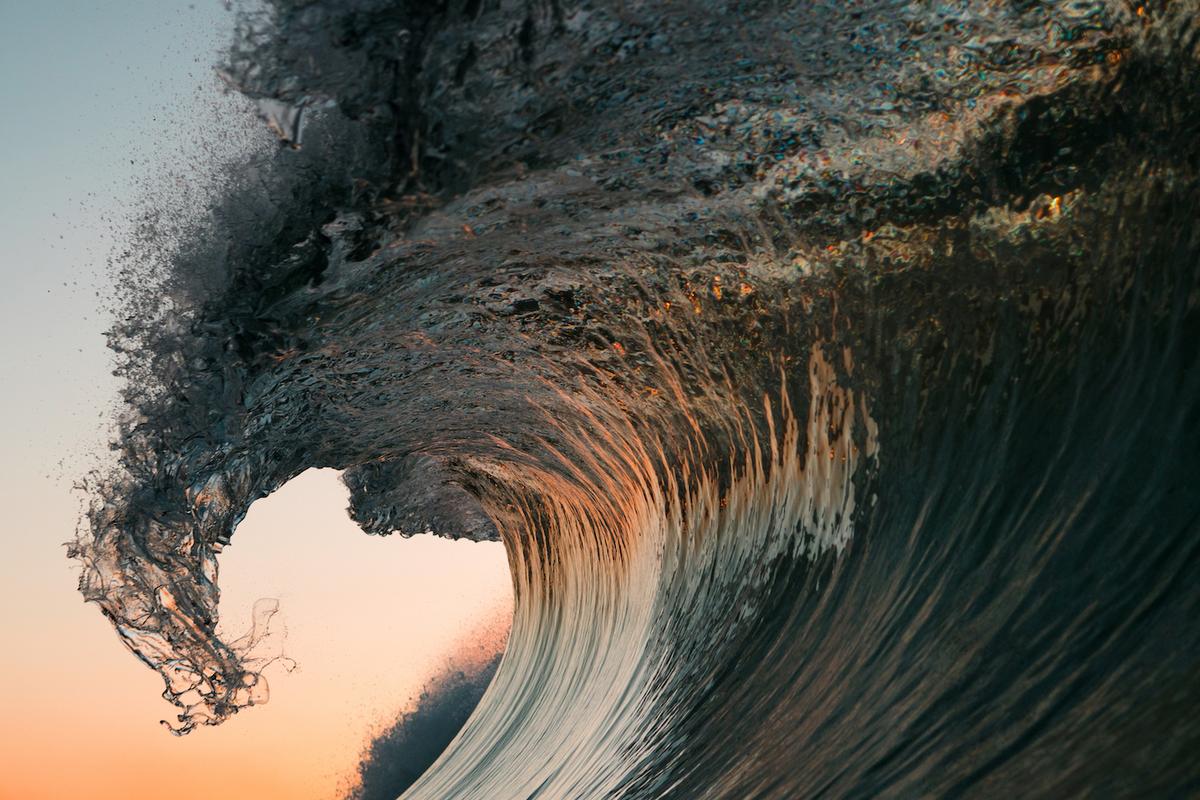 Reflections of peach sunlight appear inside the curved tunnel of this wave. (Courtesy of <a href="https://www.instagram.com/orangerocks.za/">Terence Pieters</a>)