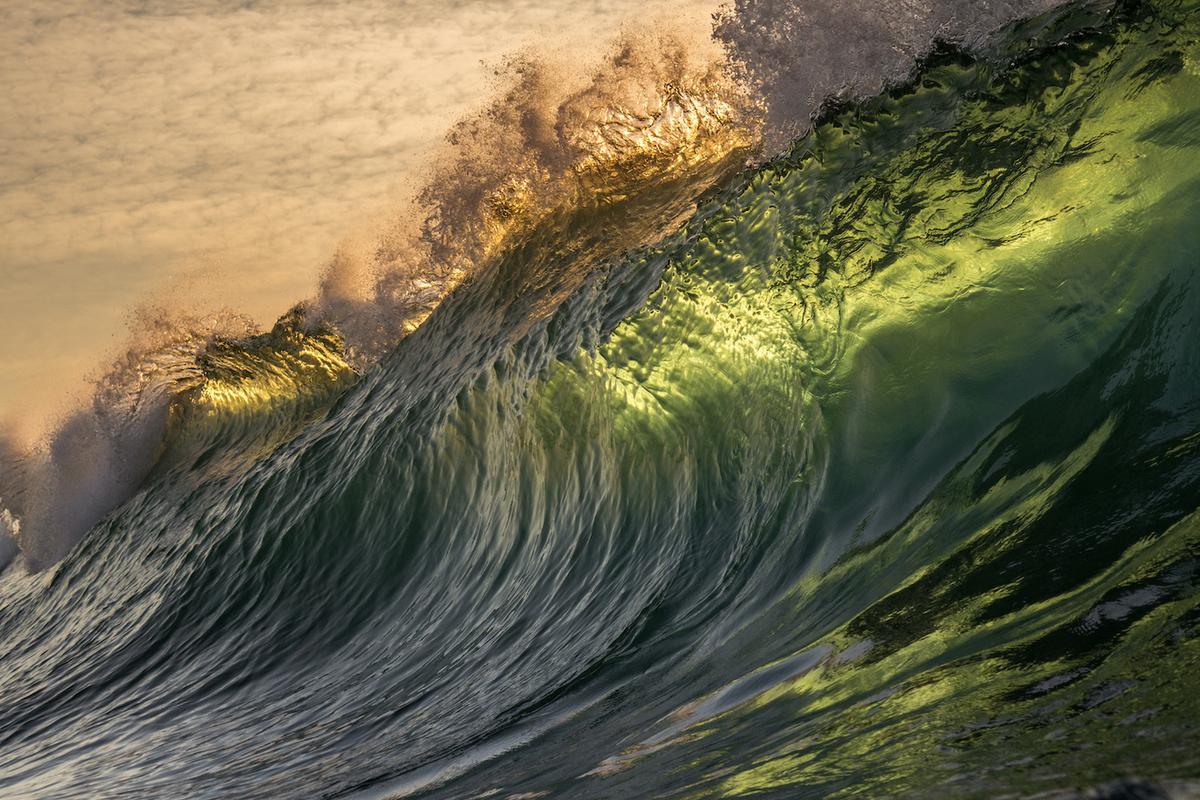 A wave appears like green glass backlit by the sun. (Courtesy of <a href="https://www.instagram.com/orangerocks.za/">Terence Pieters</a>)