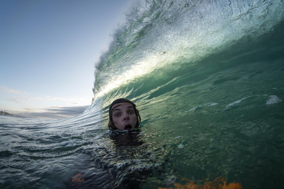 Terence Pieters takes a selfie with a humongous transparent wave looming overhead. (Courtesy of <a href="https://www.instagram.com/orangerocks.za/">Terence Pieters</a>)