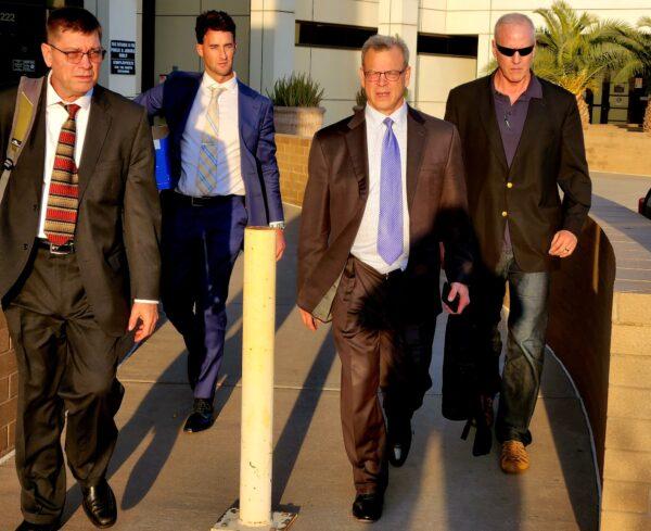Kurt Olsen (C), an attorney for Republican gubernatorial candidate Kari Lakes, leaves the Superior Court of Maricopa County in Mesa, Ariz., on Dec. 22, following a two-day civil trial. (Allan Stein/The Epoch Times)