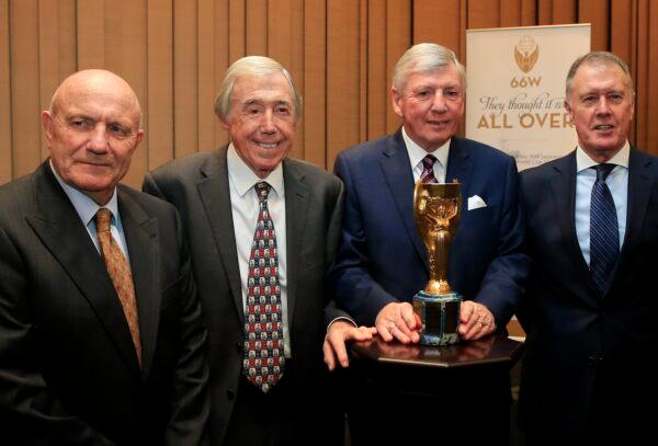 Members of the England 1966 World Cup winning team, from left, George Cohen, Gordon Banks, Martin Peters, and Geoff Hurst pose for the media with the official English Football Association replica of the Jules Rimet trophy, at the Royal Garden Hotel in London on Jan. 5, 2016. (Alastair Grant/AP Photo)