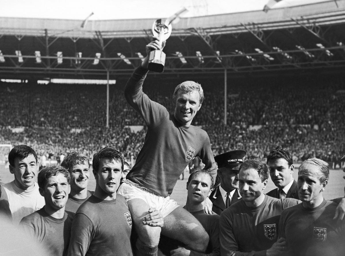 English soccer team captain Bobby Moore hoists the World Cup as he's carried by his teammates at Wembley Stadium in London on July 30, 1966. (AP Photo/Bippa)