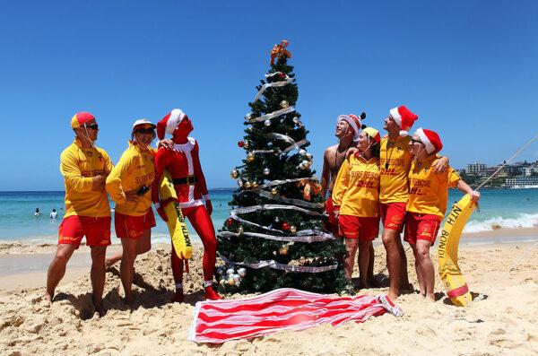 Lifeguards from North Bondi attend to a giant Christmas tree they erected at Bondi Beach in Sydney, Australia, on Dec. 25, 2010. (Don Arnold/Getty Images)