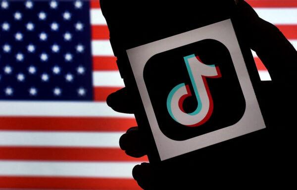 The logo for social media app TikTok is displayed on the screen of an iPhone on an American flag background in Arlington, Va., on Aug. 3, 2020. (Olivier Douliery/AFP via Getty Images)