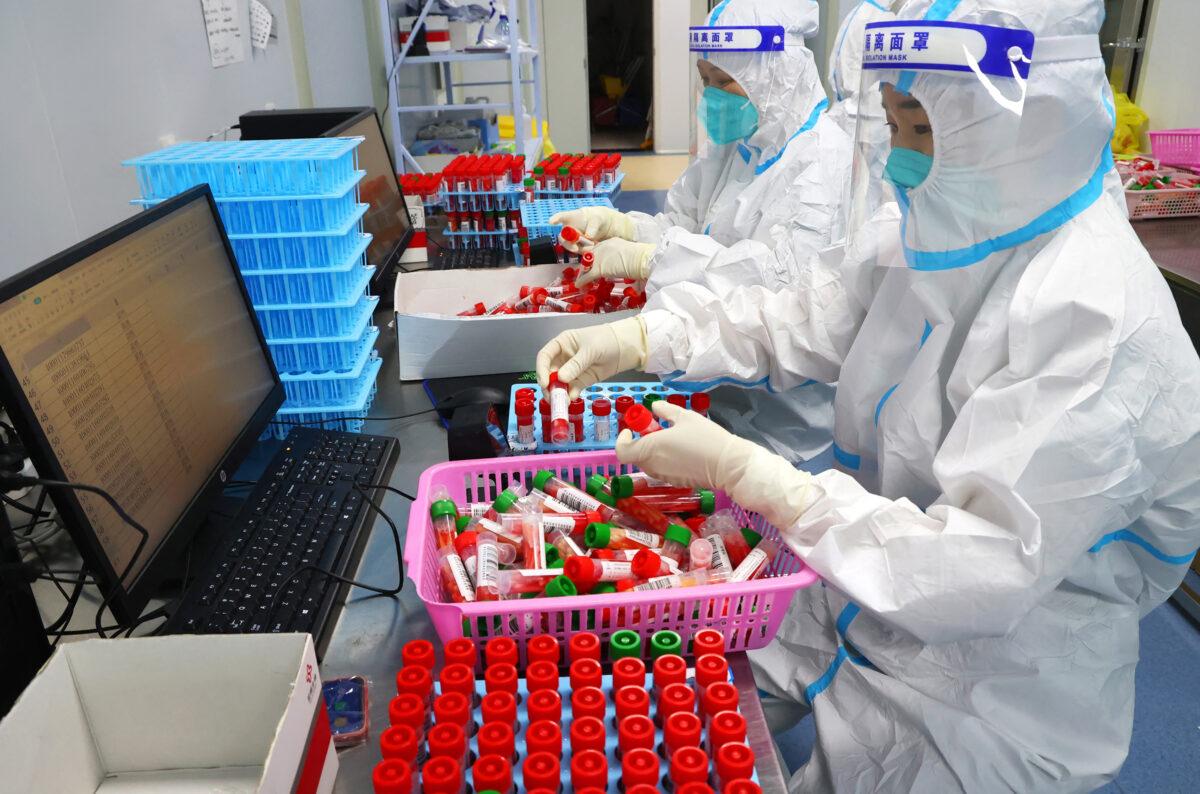 Laboratory technicians work at a Covid-19 testing facility in Lianyungang in China's eastern Jiangsu province on Aug. 23, 2022. (AFP via Getty Images)