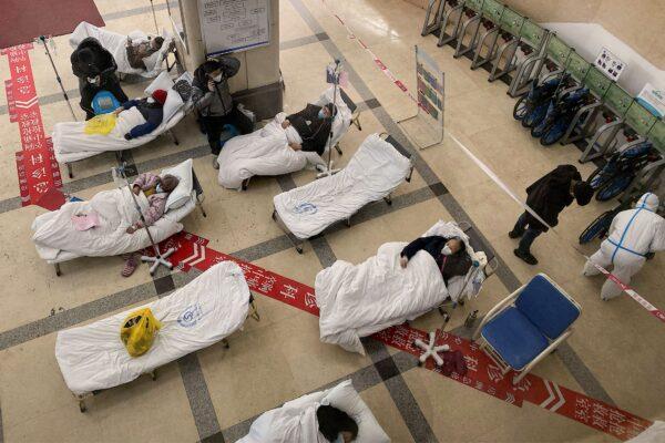 COVID patients lie on hospital beds in the lobby of the Chongqing No. 5 People's Hospital in China's southwestern city of Chongqing on Dec. 23, 2022. (Noel Celis/AFP via Getty Images)
