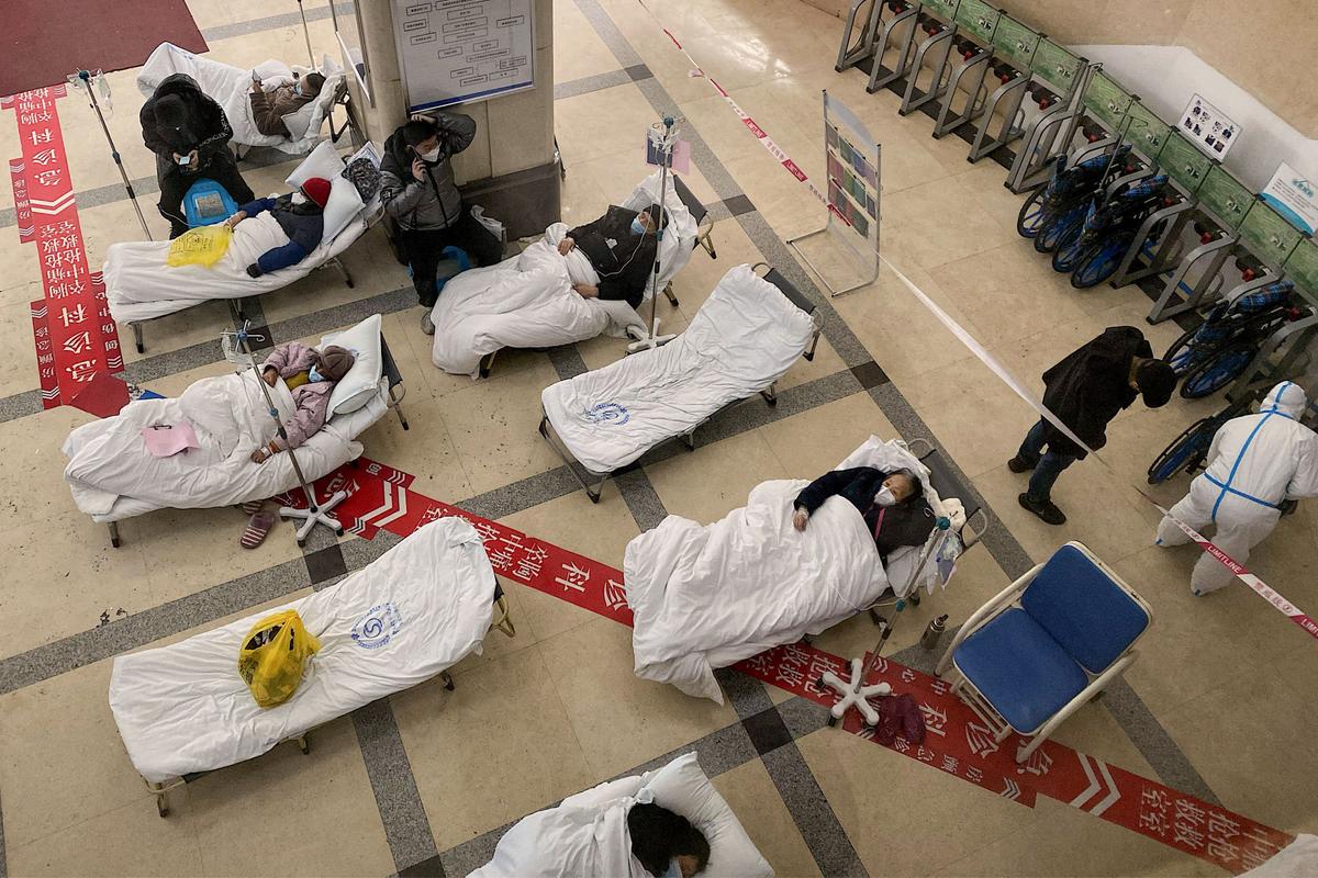 COVID-19 patients lie on hospital beds in the lobby of the Chongqing No. 5 People's Hospital in China's southwestern city of Chongqing on Dec. 23, 2022. (Noel Celis/AFP via Getty Images)
